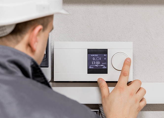 building engineer with thermostat